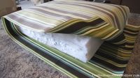 DIY cushions for patio furniture. Super easy. I didn't have old cushions to cover so I used layers of cheap bed padding foam wrapped in batting. Look here for how to do boxed corners that are not covered well http://craftapple.wordpress.com/2007/09/01/sewing-tip-squarely-boxing-those-corners/