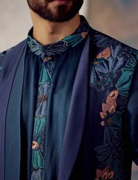 Editor's Note Featuring Ombre Shrug Set With Placement Floral Hand-embroidery. Paired With Embroidered Kurta And Matching Tapered Trousers Fabric: Linen Silk Color: Blue Component: Shrug, Kurta, Trousers Care: Dry Clean Only About the Designer After establishing himself as the leading couturier in the industry of menswear, Jatin Malik went on to explore luxury footwear. You can order online these amazingly designed handmade shoes that are being offered in classy Caligae and Peshawari patterns! W