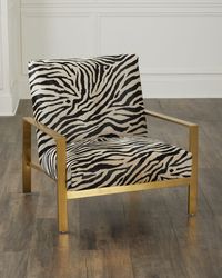 Featuring zebraprinted haironhide (Brazil) upholstery, the Fallon Chair is handcrafted of engineered hardwood with a sleek golden finish.   Overall, approx. 32"W x 33"D x 32"T   Seat, 28"W x 21"D x 17"T   Arm height, 21"   Finished back   Weight, 30.0 lbs   Made in USA from imported materials   Boxed weight, approximately 35.0 lbs