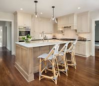 Light And Dark Beige Shaker Cabinets Modern l-shaped kitchen photo with dark wood floor, a farmhouse sink, shaker cabinets, dark-light beige cabinets, white quartz countertop, black quartz countertop, white backsplash, slab stone backsplash, stainless steel appliances, an island, and glass pendant lightings.