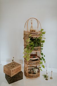 Rent this vintage round wicker + rattan display shelf for wedding styling + decor from Orange Trunk Vintage Rentals in Calgary, Alberta, Canada. Style your vintage wedding decor with vintage glasswares, wintage books, and brass candlesticks for whimsical boho vibes.