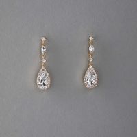 Enhance your bridal ensemble with these exquisite wedding earrings featuring a pave set elongated pear drop, delicately suspended from petite round and marquise CZ stones.They are 1.5 inches long, post pierced backs, rhodium, rose gold or gold plated, grade AAA CZ stones, lead, cadmium, and nickel free.