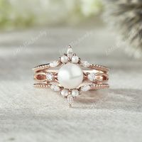 Akoya Pearl Engagement Ring Set Rose Gold Moissanite Ring Enhancer Vintage Pearl Wedding Ring Set Pearl Curved Wedding Band Gift For Her ◆RING DETAILS: ❃Engagement ring: Centre Stone: Akoya Pearl Size: 6.0mm Side stone: Round cut : Moissanite Clarity - SI-VS Color- G-H ❃Band Width:1.6mm ❃Wedding band: Round cut : pearl Marquise cut: Moissanite Clarity - SI-VS Color- G-H Band Width: 5.3mm ◆All ring sizes are available, If you can't find your ring size in the list, please feel free to contact me.