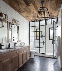 Wood ceiling and floor along with black accents in the white bathroom - Decoist