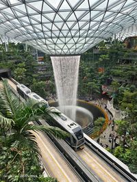 Jewel Changi Airport (also known as Jewel or Jewel Changi) is a nature-themed entertainment and retail complex surrounded by and linked to one of the passenger terminals of Changi Airport, Singapore. Its centrepiece is the world's tallest indoor waterfall, the Rain Vortex, that is surrounded by a terraced forest setting.