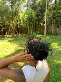 Natural hair mini twists tied into a bun are a go to.can be washed and styled for any occasion.pink nails and gold jewelry are a statement to