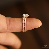 Today we have a beautiful and minimalist 8x6mm oval moissanite solitaire engagement ring accompanied by a creative 3/4 eternity marquise and round moissanite wedding band made for you in 14k yellow gold and as always available in 14k white, yellow or rose gold. This ring has a total carat weight of 2.15 carat.  Specifics ♦Total Carat Weight (TCW): 2.15 carats ♦Main Stone Carat Weight: 1.50 carat (8x6mm) ♦Main Stone Shape: Oval cut ♦Main Stone Color: D, E, F color (completely colorless) ♦Main Sto