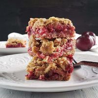 Plum Oatmeal Bars With Crumble Topping layer a tart plum filling with a crunchy sweet buttery, oat-filled crust seasoned with cinnamon.