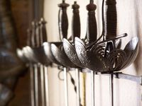 Unusual weapons rack... A beautiful offering of swords... not your basic fencing gear...