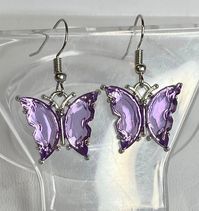 Adorable purple butterfly earrings are just the thing to adorn your earlobes with flash and color, without being too much. Perfect for when long dangly earrings just won't do.These measure 1.5" (Approximate measurement, includes ear wire) Stainless Steel ear wires, metal alloy and glass charm. Any metals used in jewelry are Zinc alloy (lead and nickel free), tarnish resistant (except for copper, which will change color(patina) over time). Metals are either bare copper, silver-tone, or gold-tone,