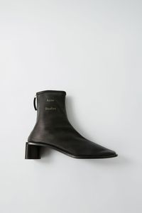 Acne Studios Bertine black/black boots are crafted from supple leather with a sock-like fit and set on a stacked block heel.