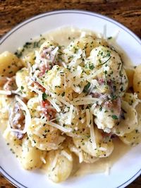 Amazingly tender gnocchi are bathed in two of the best things in the world: bacon and cream, then sprinkled with cheese for one of the best dishes ever.