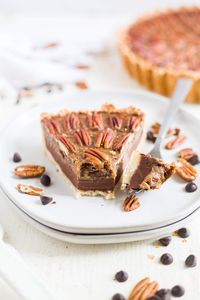 This chocolate paleo pecan pie recipe is dairy free, gluten free and refined sugar free! It's a great clean eating recipe for Thanksgiving. The crust is made with almond flour and coconut flour and the filling has no corn syrup and is made with rich chocolate and salted caramel. #thanksgiving #healthy #pecan #pie #chocolate #dairyfree #glutenfree #paleo #dessert