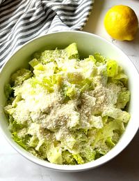 This simple 4-ingredient Nana's Crunchy Lemon Parmesan Salad will be a new favorite when you want something fresh and easy to make. Each bite is bursting with lemon flavor and salty parmesan cheese.