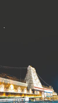 The Tirumala Temple, also known as the Sri Venkateswara Swami Temple, is a beacon of Hindu faith nestled in the Tirumala hills at Tirupati, Andhra Pradesh, India. This majestic temple is dedicated to Lord Venkateswara, an incarnation of Vishnu, revered as the 'Kaliyuga Prathyaksha Daivam' – the deity visible to humans in the troubled age of Kali Yuga. The temple's origins are steeped in legend and history, with its administration overseen by the Tirumala Tirupati Devasthanams (TTD), under the governance of the Andhra Pradesh Government.  Architecturally, the temple is a marvel of South Indian design, with its construction believed to have spanned several centuries, beginning as early as 300 CE. The temple stands on the seventh peak of the Seshachalam Hills,