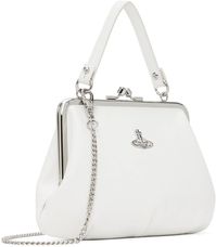 Vivienne Westwood.White Granny Frame Bag.Grained faux-leather top handle bag in white..· Detachable carry handle.· Detachable curb chain crossbody strap.· Logo hardware at face.· Kiss-lock closure.· Zip pocket at interior.· Twill lining.· Silver-tone hardware.· H6' x W8.5' x D3'.Supplier color: White.58% recycled polyurethane, 42% polyurethane..Made in China..241314F046012