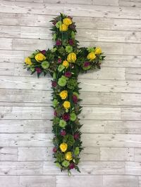 A striking cross tribute for a funeral or church service. Made with yellow roses, green chrysanthemums, lisianthus and hydrangea. #flowercross #floral #floralcross #funeral #funeralflowers