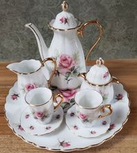 This AVON Small Treasures Miniature Porcelain Tea Set is perfect for all occasions. The set includes a lids, creamer, sugar bowl, tea pot, cups, saucers, display plate all beautifully crafted with a delicate rose gold trim. The tea set is made of high-quality porcelain. The set is a vintage original from the 1980s and was manufactured in Japan. It is a perfect addition to any collection or for daily use. Enjoy displaying this elegant and timeless AVON tea set.  Previously Owned - Excellent Condition - NO chips - NO cracks!