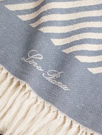 Loro Piana's 'Moai' beach towel "evokes the summertime vibes of faraway islands." Made from soft cotton, it's decorated with bouclé stitches and has soft fringed ends. It'll keep you warm on the flight back home, too.