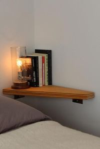 Floating table in lieu of a bedside table