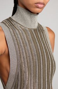 Metallic fibers bring eye-catching shimmer to this slinky sweater-dress fashioned with a high mock neck and deeply carved armholes. 35" length (size Medium) Slips on over head Mock neck Sleeveless 60% virgin wool, 28% viscose, 12% metallic fibers Unlined Dry clean Made in Italy Designer Clothing