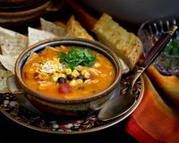 Easy to prepare creamy Chicken Enchilada Soup with shredded chicken, black beans, corn, diced tomatoes, and melted cheese. So comforting and delicious!