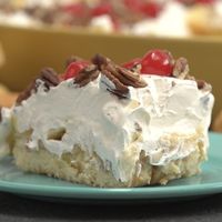 Twinkie Pudding Cake   1 box Twinkies    4 bananas, peeled and sliced    1 can (20 oz) crushed pineapple, drained well    1 box (3 oz) instant vanilla pudding    2 cups cold milk    1 tub (8 oz) Cool Whip, thawed    Maraschino cherries, dried on paper towel    Pecans, chopped,