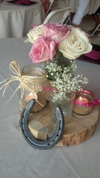 Rustic wedding shower center pieces using all different sizes mason jars / http://www.deerpearlflowers.com/rustic-farm-wedding-horseshoe-ideas/