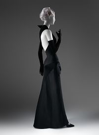 In the postwar period James was increasingly drawn to the muted sophistication of contrasting materials of differing luster. In this evening dress’s monochromatic duet of blacks, the dull sheen of jersey juxtaposes with the high shine of satin