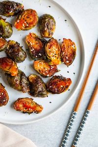 Roasted gochujang brussels sprouts are delicious way to make spicy brussels sprouts. The gochujang sauce adds so much flavor to the sprouts and will turn brussels sprouts haters into lovers.