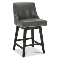 This 26" counter stool brings a classic touch to your kitchen island or home bar. Its full back and seat are upholstered in black faux leather, with nailhead trim adding a sophisticated element. The frame, made from a combination of solid and engineered wood, showcases an espresso finish that complements the dark seat. We love that its 360-degree swivel range allows for easy movement and conversation, while the footrest provides extra comfort. Designed with water-resistant materials and leg leve