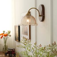 Bring a touch of nature into your home with our Vintage flower sconce light fixtures. The elegant walnut base design paired with a glass shade creates a warm and inviting ambiance in any room. With its unique and eye-catching design, this wall-mounted lamp is perfect for those looking to add a touch of personality to their home decor.