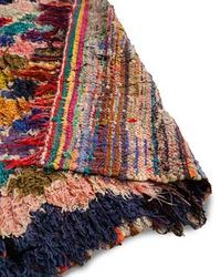 This authentic vintage boucherouite rug we hand-selected from the Medina in Marrakech. This wool rug was handwoven by members of the Berber tribe from the Ourika Valley in the High Atlas mountains. Ourika boucherouite rugs are are handwoven for use in the home using undyed, organic wool and feature traditional Berber motifs. The name boucherouite (pronounced "boo-shay-reet”) is derived from a Moroccan-Arabic word that means a "scrap" because it is made from excess yarn and recycled rugs. The res