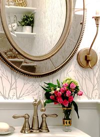 Powder Room with wallpaper and wainscoting combines champagne and silver finishes for an elegant statement #powderroomdecor #powderroomwallpaper