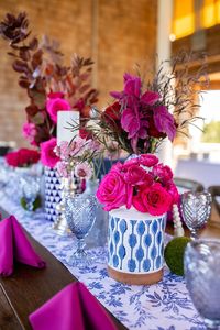 Blue and white ginger jar wedding centerpieces with bold pink flowers for unique coastal wedding decor ideas #weddingdetails #weddingflowers #weddingcenterpieces #gingerjars #weddings #weddingideas #outerbanks #weddingdecor