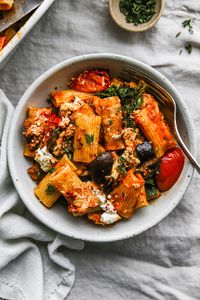 This cozy baked pasta recipe is packed with nutritious veggies like roasted eggplant (aubergine), tomatoes, zucchini, and kale. It’s topped with cheeses like parmesan and ricotta, which get nice and melty in the oven! Recipe is vegetarian and can easily be made gluten-free.