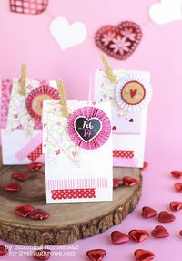 If you haven’t already checked out the super cute valentines products available at the Target dollar section, you are missing out! I was planning to put together a few simple Valentine Treat Bags this year and when I ran across these fun rosette tags and pink polka dot fabric tape I was smitten.