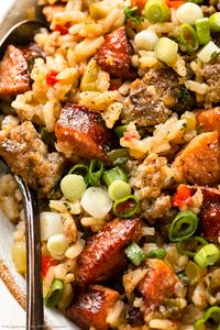 Slightly angled, overhead close-up photo of double sausage rice in a white bowl.