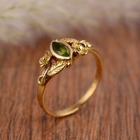 "Natural Peridot Ring, Dainty Ring, Brass peridot Ring, Engagement Ring, Gemstone Ring, Women Ring, Minimalist Ring, Statement Ring ♥ SIZE:- All Size Are Available, choose from variation. ♥ METAL:- Brass ♥ STONE:-Peridot ♥ SOME BENEFITS OF THE PERIDOT ARE ♥ *Peridots increase strength and vitality in people. *They have a calming effect on the wearer. ... *They increase strength in people and reduce anxiety. *When used as a ring, they become a protector against negative emotions. *They are known