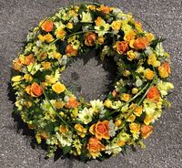 Brightly coloured yellow and white large funeral wreath, created by Signature Flowers Bucks and Oxon.  #funeralflowers #bespokeflowers #bespokefuneralflowers #bicesterflorist #oxfordshireflorist #sayinggoodbye #funeralwreath