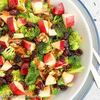 This broccoli apple salad is made with raw broccoli, carrots, sweet apples, red onion, toasted pecans, dried cranberries and maple dressing.