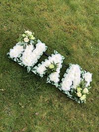 A classic NAN funeral tribute in greens and whites with sprays of carnation, roses, jasmine and foliage’s.   #funeral #funeralflowers #nan #sympathyflowers