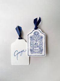 Blue toile effect placenames, inspired by the ceramic tiling at the wedding venue