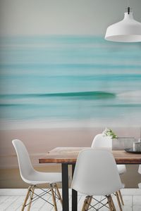 Want a truly mesmerising wallpaper mural? Lose yourself in this hazy beach wallpaper mural. Showing the calm waters gently lapping over the shore, marrying together shades of pastel. Its resemblance of a watercolour painting helps to create a calming environment in your home.