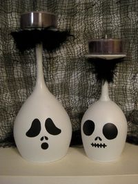 Make them yourself candle holders.. white and black paint (able to hold on to glass), red wine glass or white wine glass, some black feather and black candles that will fit on the base of the wine glass.