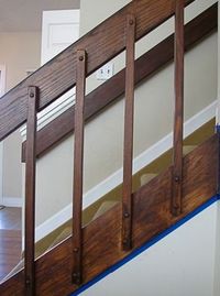 Our '80s banister in our tri-level house was an orange-colored oak. I replaced the oak trim with white and changed the entryway closet door. Replacing the banister was too expensive, so I stained it dark brown. Shortly after we moved into our awesome ’80s house, I painted all the trim on the main floor white. I hoped it would brighten and update the space. And it did—sorta. But it also called attention to the orangey-brown door, remaining trim, and banisters.In our tri-level house,…