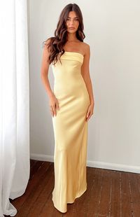 * Yellow Strapless Maxi Dress   *     * HOW TO STYLE:   * The perfect formal dress () for the spring and summer seasons! The stunning pastel yellow adds a pop of colour to this classic strapless maxi dress (). Elevate the look with dainty gold jewellery () and nude strappy heels.    *     * FEATURES:   *  Bias cut with slight stretch   * Strapless with rubber grip on inner bust   * Panelled fold over on bust   * Elasticated back with cowl draping   * Flowy fit   * Invisible side zip   * Unlined