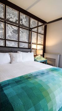 This Modern Irish hotel is set next to the Atlantic Ocean; the interior design combines modern with rustic traditional decor ideas.  While the architecture of the reception is rustic with details found in a country cottage or farmhouse. The natural seaside setting inspires the bedrooms and suites colours.   | #bed | #blanket | #headboard |