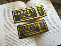 🌙 Dive into the magical world of Caraval each time you open your book, and let this unique bookmark transport you to a world of adventure and wonder.  ✨This bookmark comes in two sizes:  - 15cm x 6cm (5.9in x 2.3in) - 12.5cm x 5cm (4.9in x 2in) Inspired by the enchanting world of the Caraval series.  💫Laminated for protection in a matte or gloss finish and printed on 160gsm cardstock. The back is left plain.  ❤️The original design, crafted by me, brings to life the essence of the beloved serie