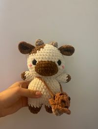 Handmade crochet chocolate cow plush with a choc-chip ice cream bag